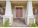 Charming front porch with decorative columns, a brick walkway, and inviting curb appeal at 3667 Arbor Chase Dr, Palm Harbor, FL 34683