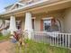 Charming front porch with a swing chair and well manicured landscaping at 3667 Arbor Chase Dr, Palm Harbor, FL 34683