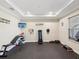 Home gym featuring rubber flooring, workout equipment, and motivational wall art for fitness enthusiasts at 3667 Arbor Chase Dr, Palm Harbor, FL 34683