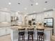 Bright and modern kitchen with white cabinetry, granite countertops, and stainless steel appliances at 3667 Arbor Chase Dr, Palm Harbor, FL 34683