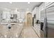 Bright kitchen features granite countertops, stainless steel appliances and white cabinets at 3667 Arbor Chase Dr, Palm Harbor, FL 34683