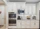 Kitchen features stainless oven, microwave and light granite countertops at 3667 Arbor Chase Dr, Palm Harbor, FL 34683