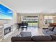 Open living room with a fireplace and large sliding doors to backyard at 3667 Arbor Chase Dr, Palm Harbor, FL 34683