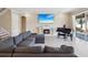 Cozy living room with a fireplace, piano, and a large sectional sofa for comfortable lounging at 3667 Arbor Chase Dr, Palm Harbor, FL 34683