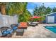 Backyard features an in-ground pool, umbrella, outdoor seating, and lush landscaping at 3727 38Th N St, St Petersburg, FL 33713