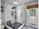 The bathroom showcases a glass shower with a rainfall showerhead and a door leading to the outside pool area at 3727 38Th N St, St Petersburg, FL 33713
