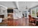 Spacious living room featuring hardwood floors, a decorative fireplace, and seamless access to the bedroom through glass doors at 3727 38Th N St, St Petersburg, FL 33713