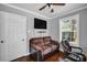 Well-lit office space, with hardwood floors, featuring a comfortable couch, ceiling fan, and plenty of natural light at 3727 38Th N St, St Petersburg, FL 33713