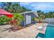 Charming pool house featuring white doors and vibrant landscaping adjacent to the pool at 3727 38Th N St, St Petersburg, FL 33713