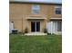 Townhouse backyard with a grassy area, concrete patio, and a white fence at 4224 Winding River Way, Land O Lakes, FL 34639