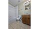 Bright bathroom with a tiled shower-tub combination, vanity with a mirror, and tile flooring at 4224 Winding River Way, Land O Lakes, FL 34639