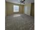 Spacious bedroom featuring neutral carpet, a ceiling fan, and a window for natural light at 4224 Winding River Way, Land O Lakes, FL 34639