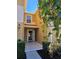 Inviting home entrance with tiled porch, complemented by manicured bushes and vibrant foliage at 4224 Winding River Way, Land O Lakes, FL 34639
