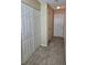 Hallway with neutral walls and flooring, and a closet with white bi-fold doors at 4224 Winding River Way, Land O Lakes, FL 34639