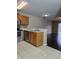 Open kitchen with stainless steel appliances, tile backsplash, and hardwood floors in adjacent living area at 4224 Winding River Way, Land O Lakes, FL 34639