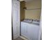 Convenient laundry room features a modern washer and dryer and wire shelving for storage at 4224 Winding River Way, Land O Lakes, FL 34639