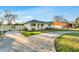 A quaint single-Gathering home with a long driveway, offering a welcoming entrance and ample parking space at 4418 Carlyle Rd, Tampa, FL 33615