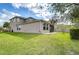 Large grassy back yard with a screen porch and plenty of space for outdoor activities at 4627 Tramanto Ln, Wesley Chapel, FL 33543