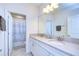 Bathroom with double sinks, white cabinets, and a shower at 4627 Tramanto Ln, Wesley Chapel, FL 33543