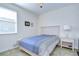 Comfortable bedroom with a bed, nightstand, and framed pictures, creating a peaceful atmosphere at 4627 Tramanto Ln, Wesley Chapel, FL 33543