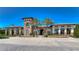 Beautiful clubhouse with stone facade, arched entrance and covered walkway at 4627 Tramanto Ln, Wesley Chapel, FL 33543