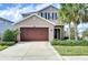 Charming two-story home featuring a spacious driveway, two car garage, and neatly landscaped front yard at 4627 Tramanto Ln, Wesley Chapel, FL 33543