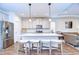 Modern open-concept kitchen with stainless steel appliances, granite countertops, and a center island with seating at 4627 Tramanto Ln, Wesley Chapel, FL 33543