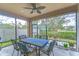 Screened lanai with an outdoor dining set and ceiling fan at 4627 Tramanto Ln, Wesley Chapel, FL 33543