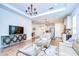 Bright and airy living space with a modern design and an open layout to the dining and kitchen area at 4627 Tramanto Ln, Wesley Chapel, FL 33543