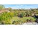 Expansive backyard featuring lush tropical landscaping and a wooden boardwalk to a picturesque view at 4707 Troydale Rd, Tampa, FL 33615