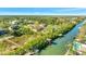 A scenic view of a canal lined with lush greenery, featuring waterfront homes and boat docks at 4707 Troydale Rd, Tampa, FL 33615