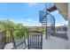 Outdoor balcony with comfortable chairs and a spiral staircase to the rooftop at 4707 Troydale Rd, Tampa, FL 33615