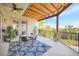 Inviting covered balcony with a dining table, ceiling fan, and picturesque outdoor views at 4707 Troydale Rd, Tampa, FL 33615