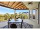 Spacious covered balcony with dining set and scenic views of lush landscaping at 4707 Troydale Rd, Tampa, FL 33615