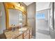 Bathroom with a granite countertop, a wooden-framed mirror, and white tile flooring at 4707 Troydale Rd, Tampa, FL 33615