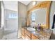 Bathroom with a granite countertop, a wooden-framed mirror, and white tile flooring at 4707 Troydale Rd, Tampa, FL 33615