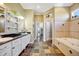 A spacious bathroom with double sinks and a soaking tub at 4707 Troydale Rd, Tampa, FL 33615