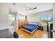 Cozy bedroom featuring a bed, hardwood floors, a ceiling fan, and a view from the window at 4707 Troydale Rd, Tampa, FL 33615