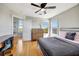 Bedroom featuring hardwood floors, a ceiling fan, a bed, and a writing desk at 4707 Troydale Rd, Tampa, FL 33615