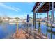 Private boat dock with lift, seating area, and umbrella for outdoor relaxation at 4707 Troydale Rd, Tampa, FL 33615