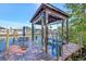 Dock featuring a boat lift, with a waterfront table and chairs, perfect for enjoying the coastal lifestyle at 4707 Troydale Rd, Tampa, FL 33615