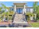 Beautiful home with a striking entrance and lush tropical landscaping for enhanced curb appeal and privacy at 4707 Troydale Rd, Tampa, FL 33615