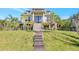 Stunning home featuring a grand entrance with staircase and lush tropical landscaping in a well-manicured lawn at 4707 Troydale Rd, Tampa, FL 33615