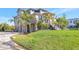Multi-story home with lush green grass and tropical landscaping at 4707 Troydale Rd, Tampa, FL 33615
