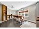 Bright, airy flex room with light gray walls, custom shelving and an oversized wood table, perfect for entertaining at 4707 Troydale Rd, Tampa, FL 33615