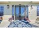 Charming front door with sidelights, decorative pots, and a welcoming patterned outdoor rug at 4707 Troydale Rd, Tampa, FL 33615