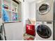 Efficient laundry room with stacked washer and dryer, plus built-in shelving for storage at 4707 Troydale Rd, Tampa, FL 33615