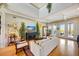 Bright living room featuring high ceilings, hardwood floors, and French doors to a balcony at 4707 Troydale Rd, Tampa, FL 33615