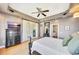 Spacious main bedroom with a tray ceiling, ceiling fan, and french doors to the outside at 4707 Troydale Rd, Tampa, FL 33615