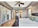 Spacious main bedroom boasts hardwood floors, tray ceilings, and French doors to outdoor space at 4707 Troydale Rd, Tampa, FL 33615